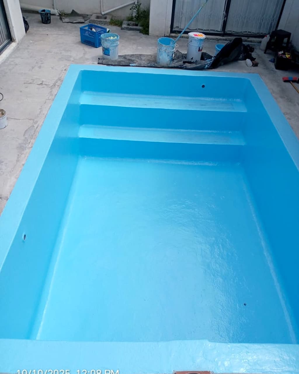 The same pool resurfaced in pale blue and ready to fill