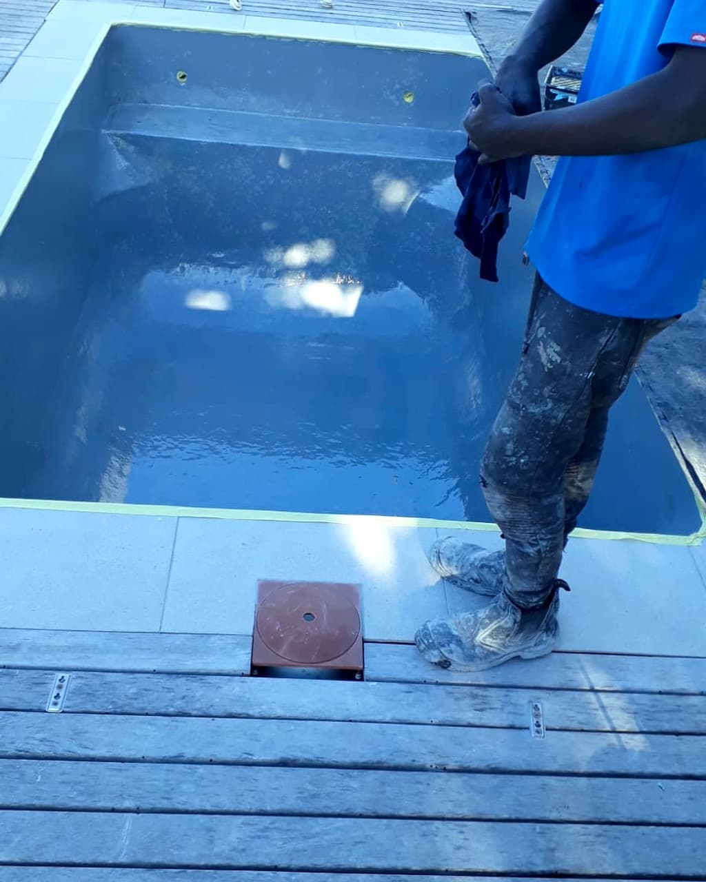 Pool paint freshly applied to a drained shell before refilling