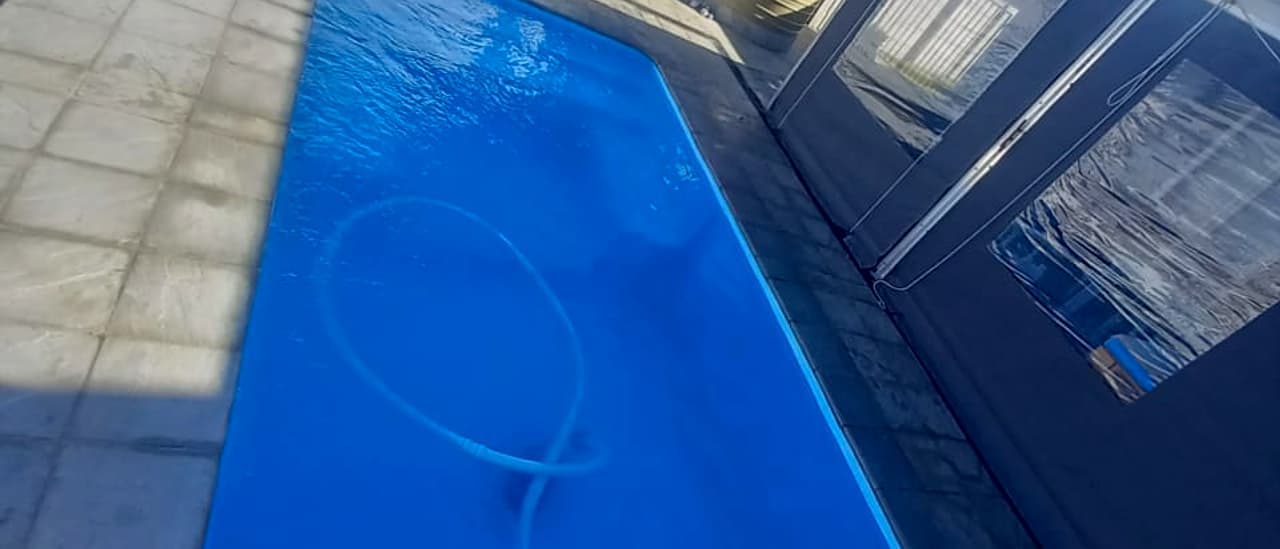 A pool restored to deep clear blue on a maintenance visit