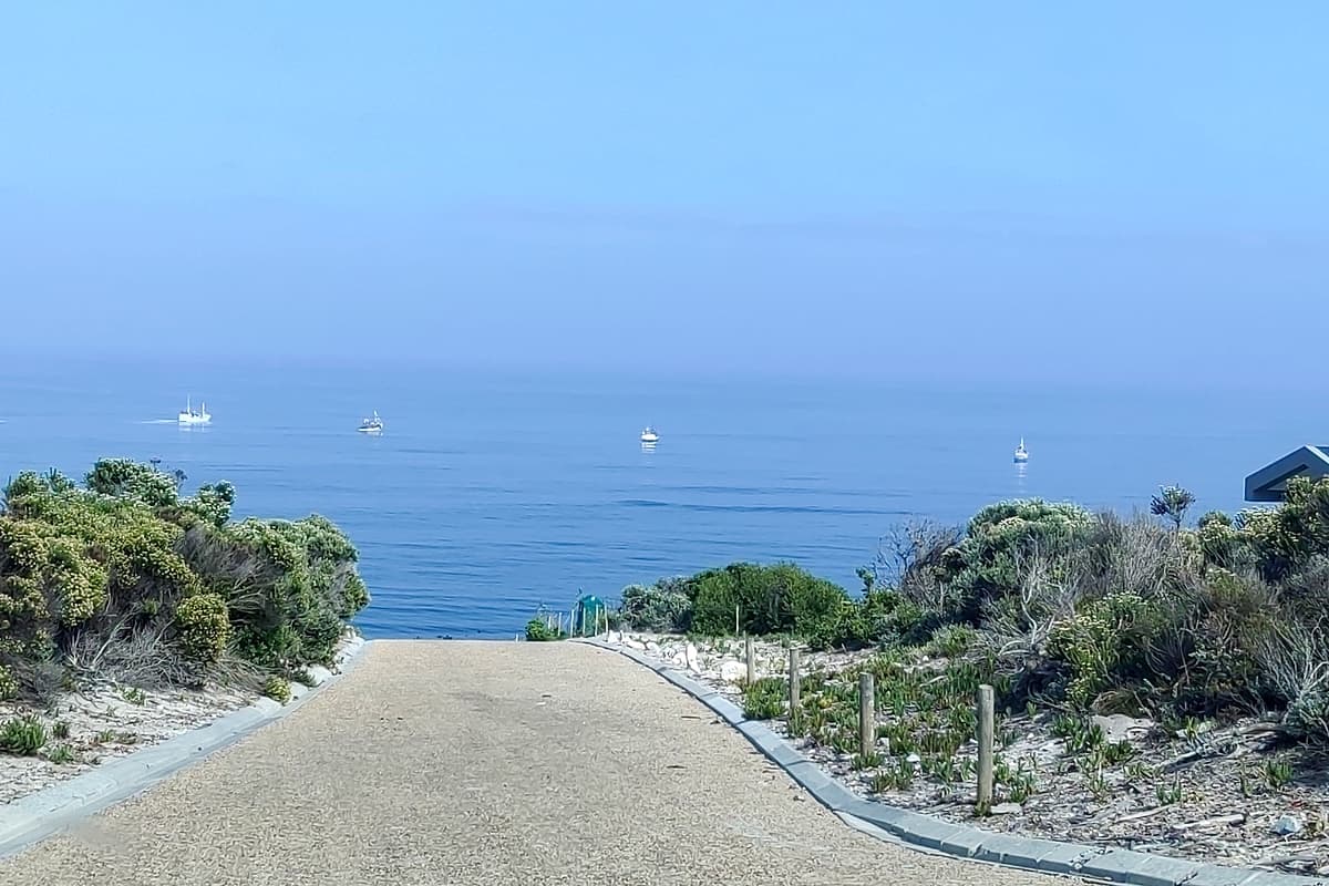 The Overberg coastline near Gansbaai, fishing boats on a calm sea — Happy Homes' service area